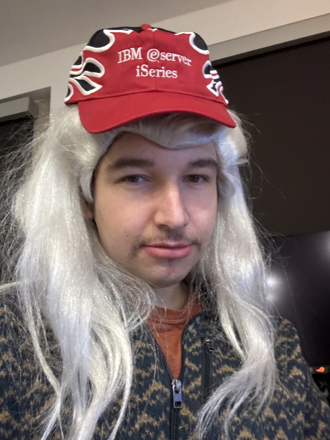 Ethan wearing a wig and an IBM eServer iSeries hat